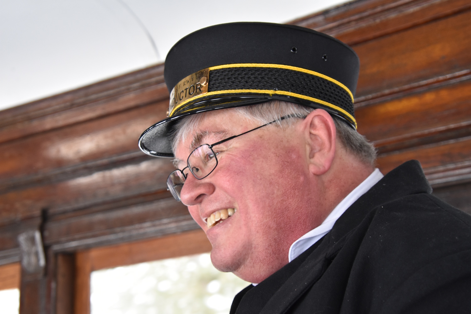 A smiling conductor is ready to great you on Maine's unique WW&F Railway.