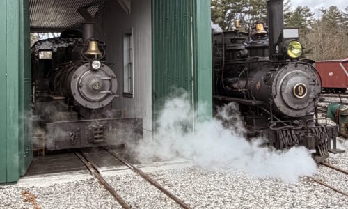 Monson locomotive 3 rests inside the Engine House while WW&F locomotive 9 looks on - at the WW&F Railway Museum in Alna, Maine.