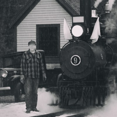 a man standing next to a train