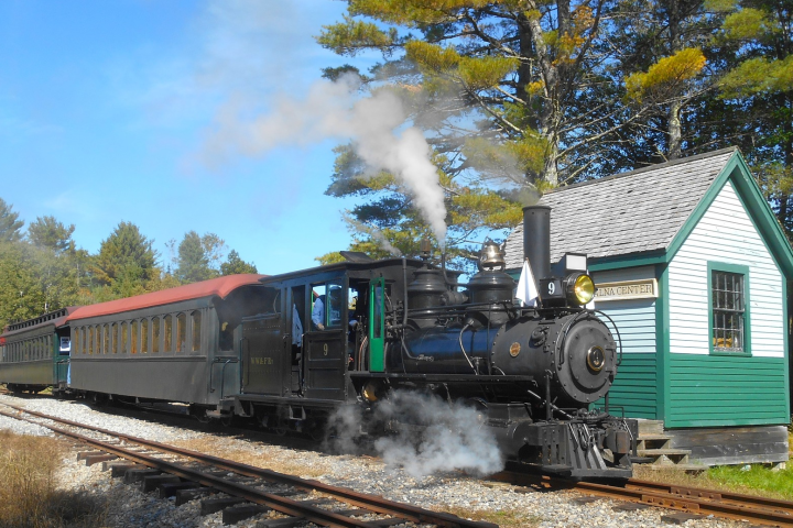 a train engine carrying carts down a track